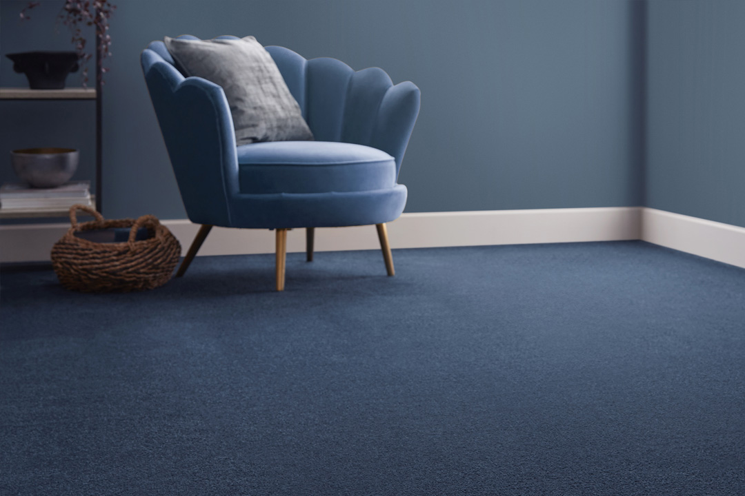 blue velvet armchair with blue carpet